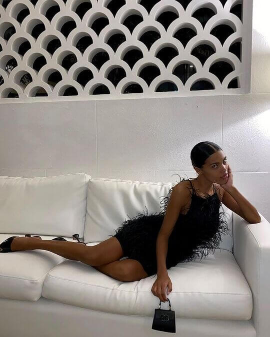 Tina Kunaki in black dress