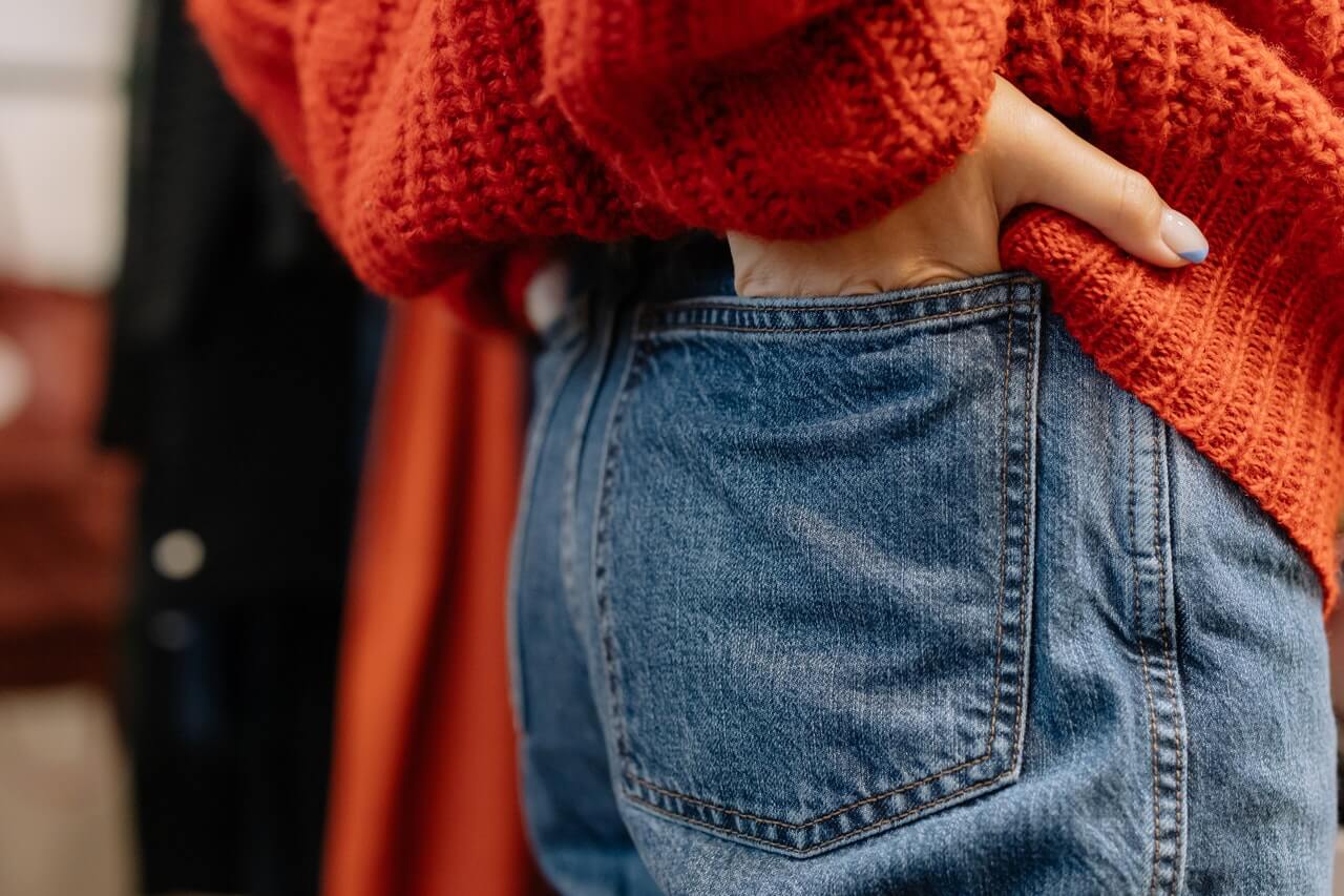 A Boy In A Red Sweater And Blue Pants Jumps And Holds His Hand Up In The  Studio On A Gray Background Stock Photo Picture And Royalty Free Image  Image 111913939